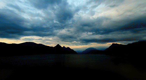 Clouds over lake and mountains