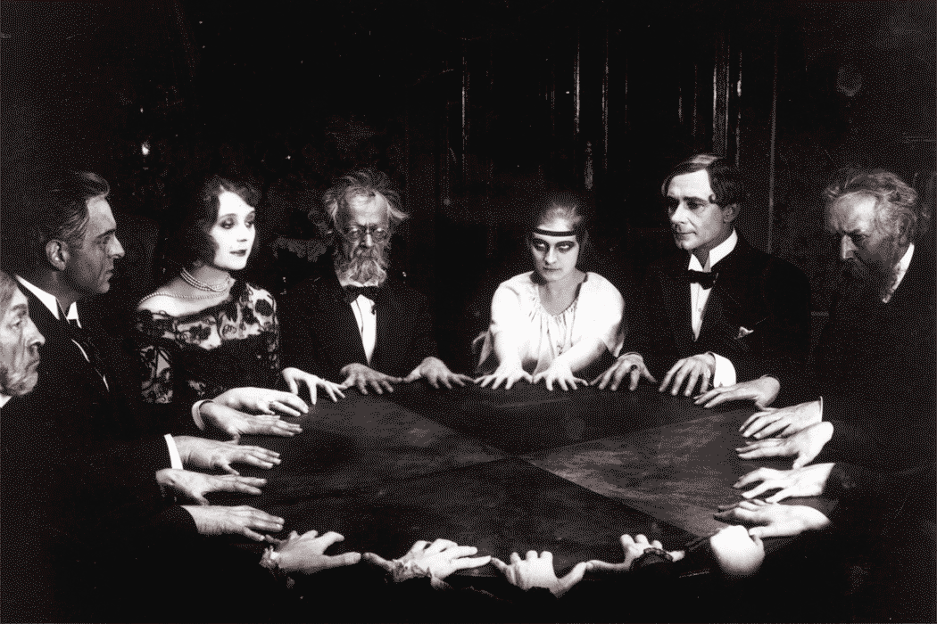 the spiritualists are siting around the table