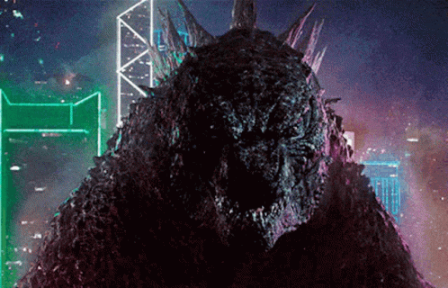 Animated GIF of Godzilla with a neon-lit cityscape background, highlighting a dramatic scene from the movie.